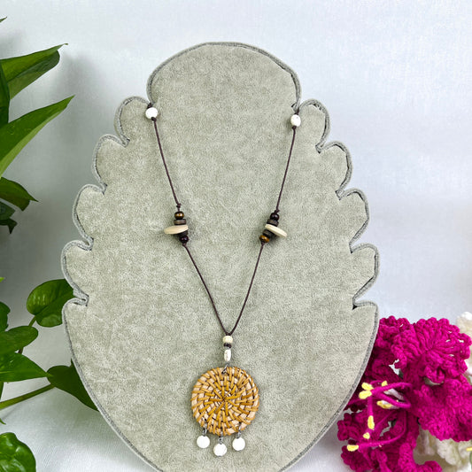 Round pendant and rattan necklace with three white beads